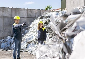 Two employees at an aluminium scrap yard.